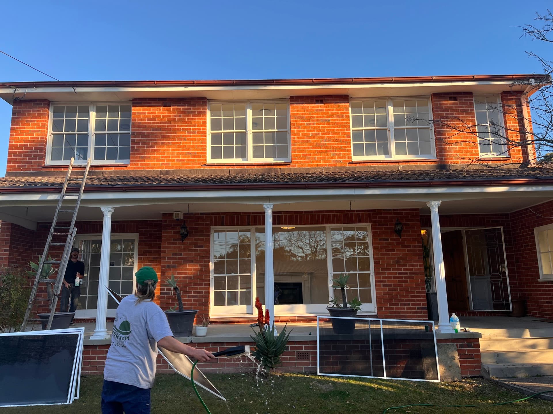 Two-storey brick home being washed