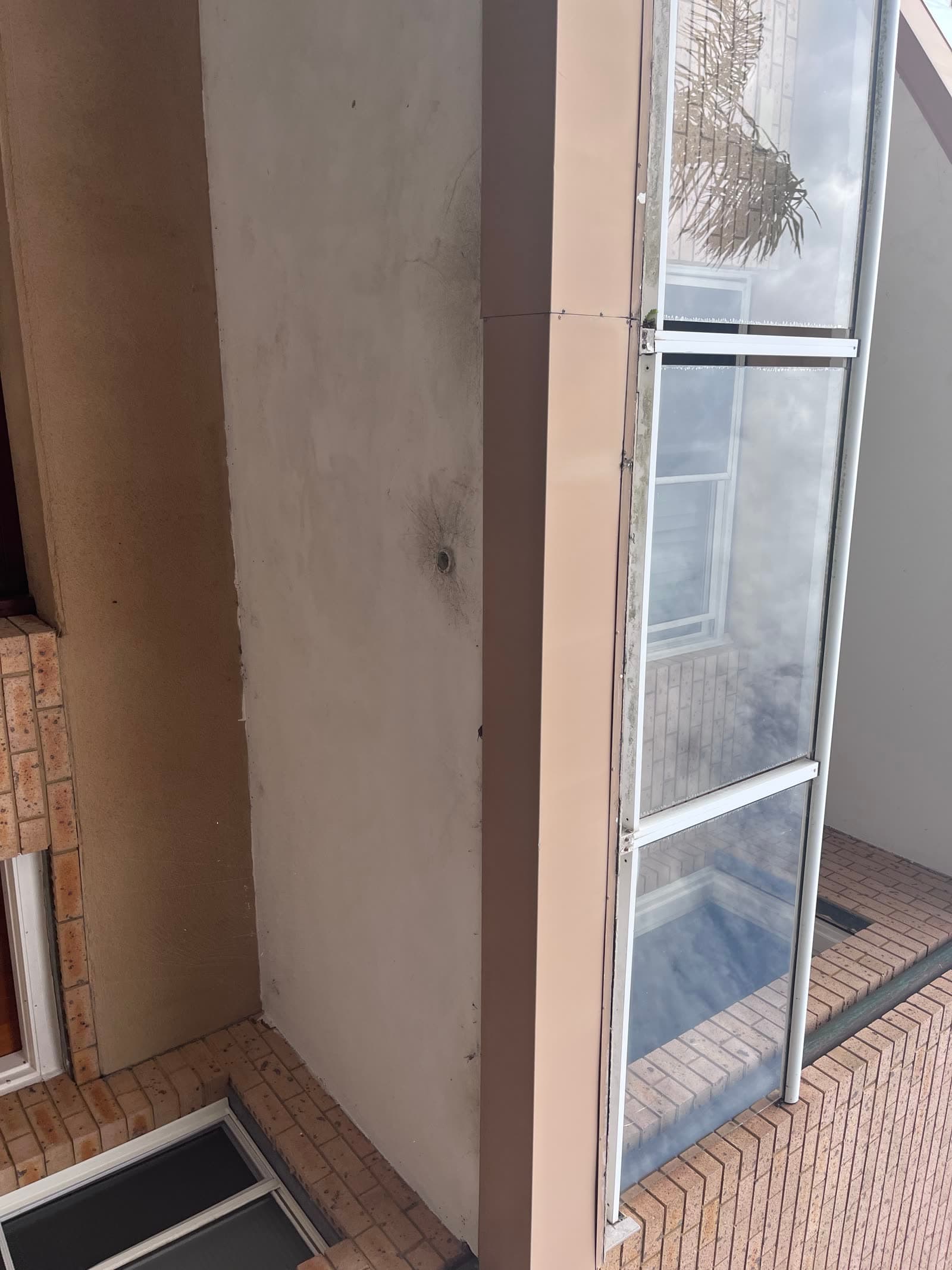 Strata balcony floor and glass balustrade before cleaning
