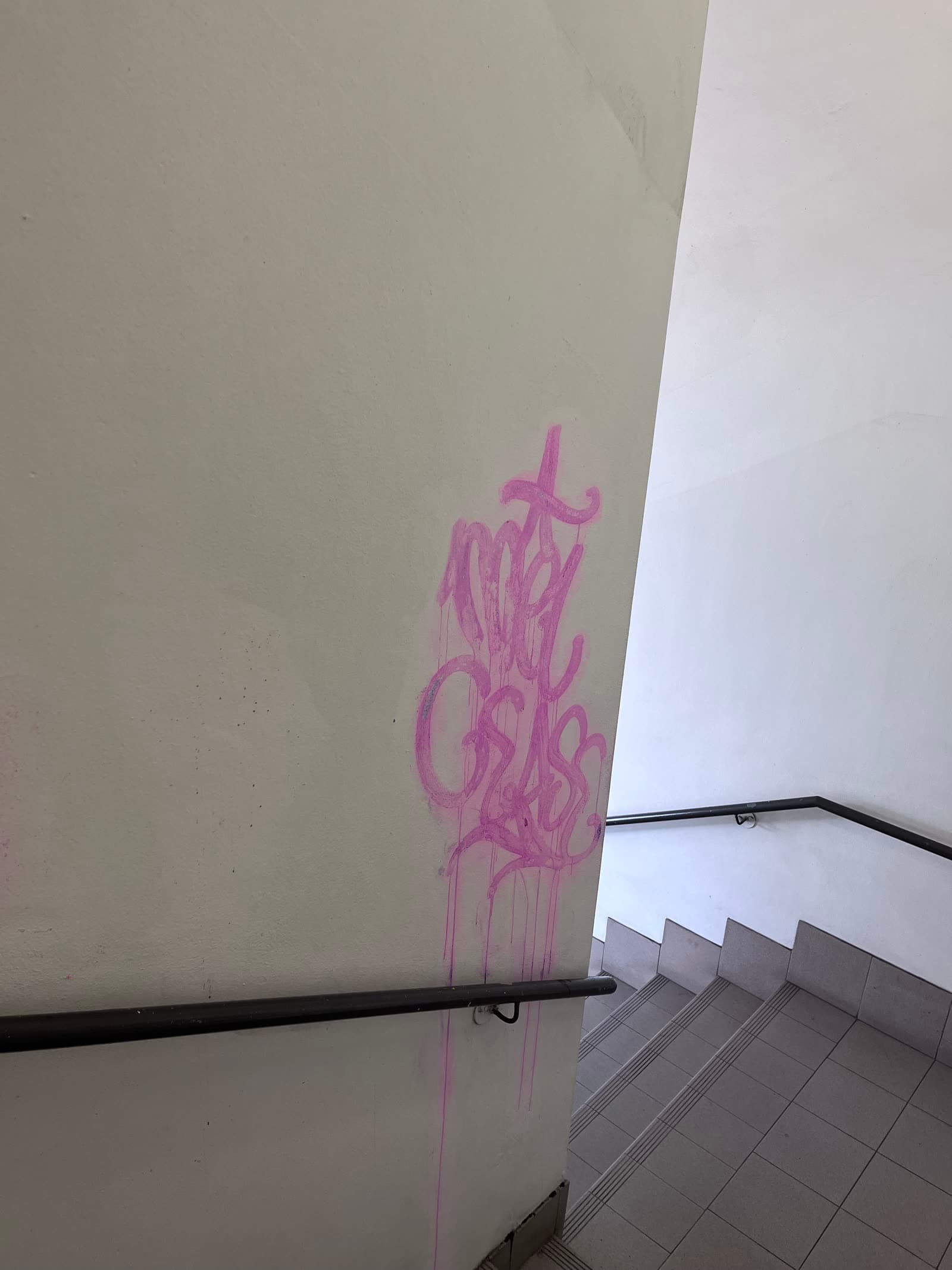 Pink spray-paint tags on render wall before Washlord removal