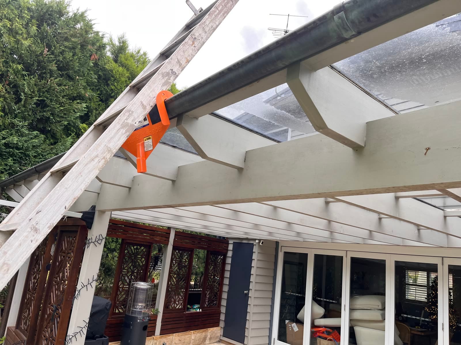 Gutter cleaning with vacuum tool on a pergola — Northern Beaches
