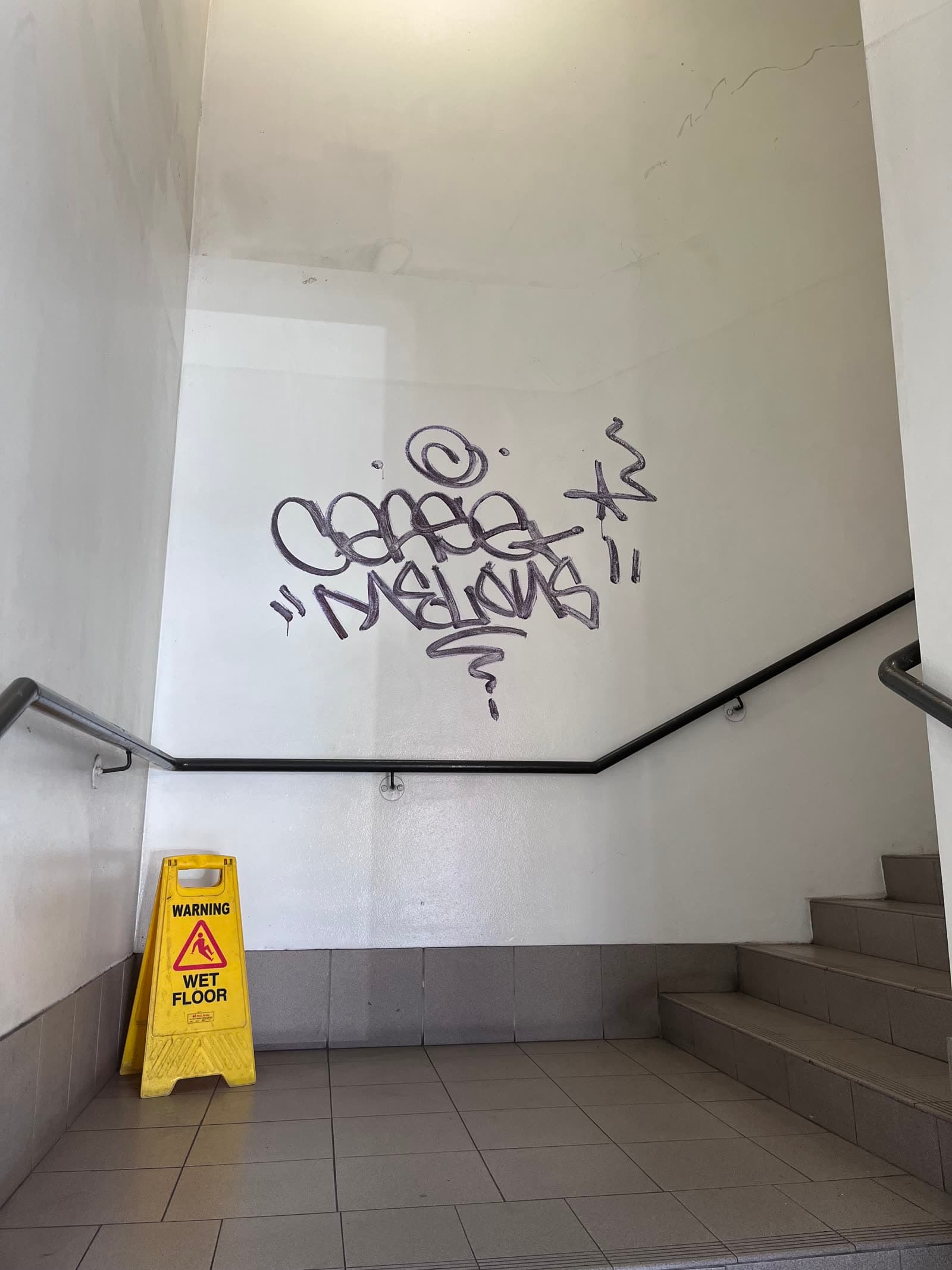 Marker graffiti tags on interior stairwell wall before removal — Northern Beaches Sydney